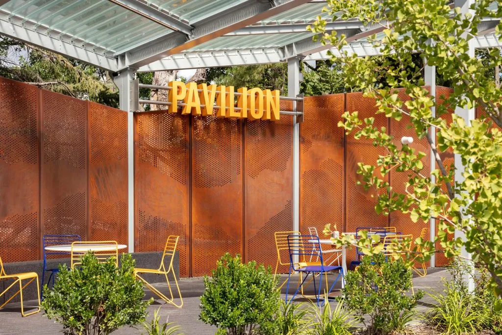 covered pavilion seating area with modern table and chairs