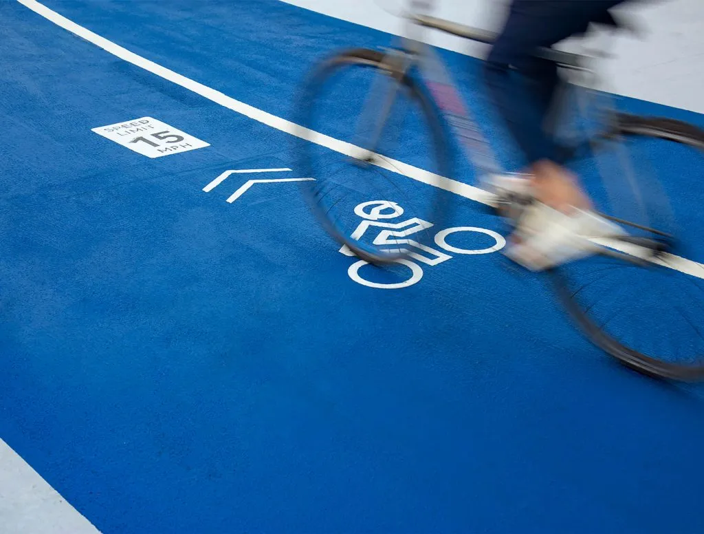 Bike riding on blue path with printed icons