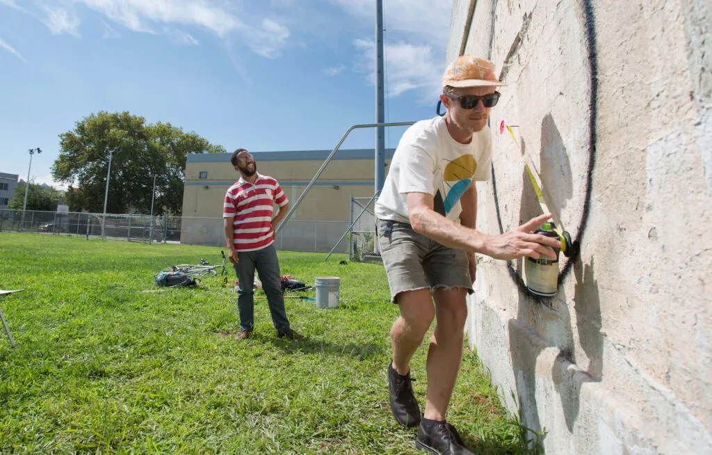 two people creating artwork for city-wide exhibition by Mural Arts