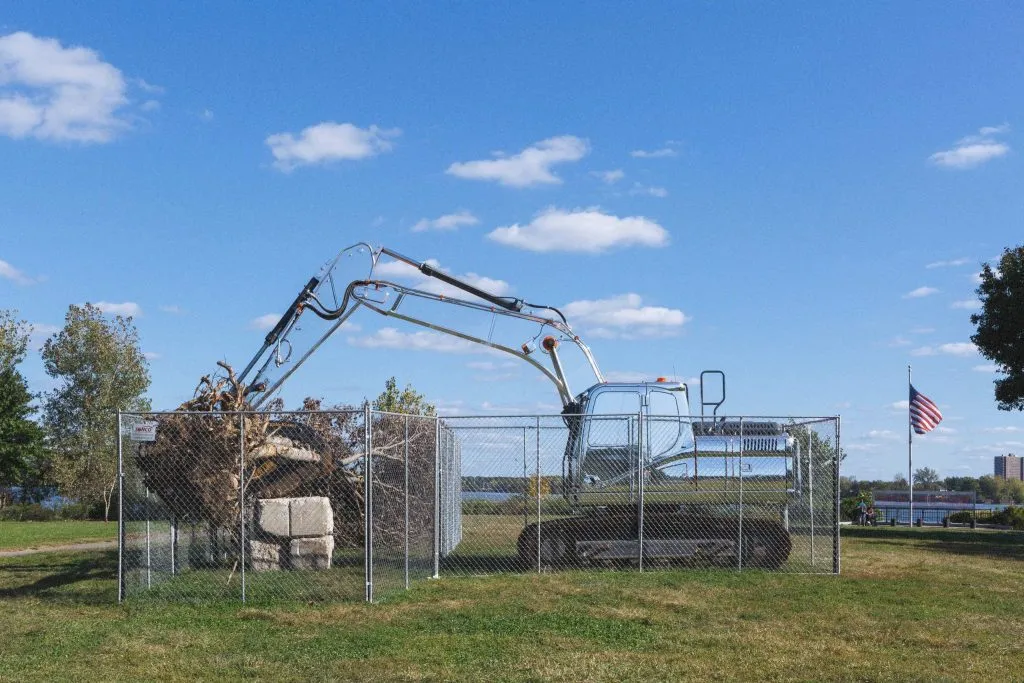 Outside art installation of transparent excavator