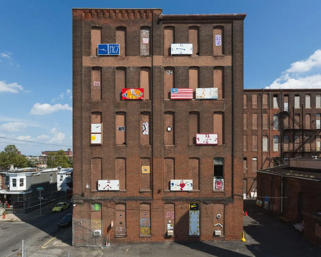 brick building facade with art installations