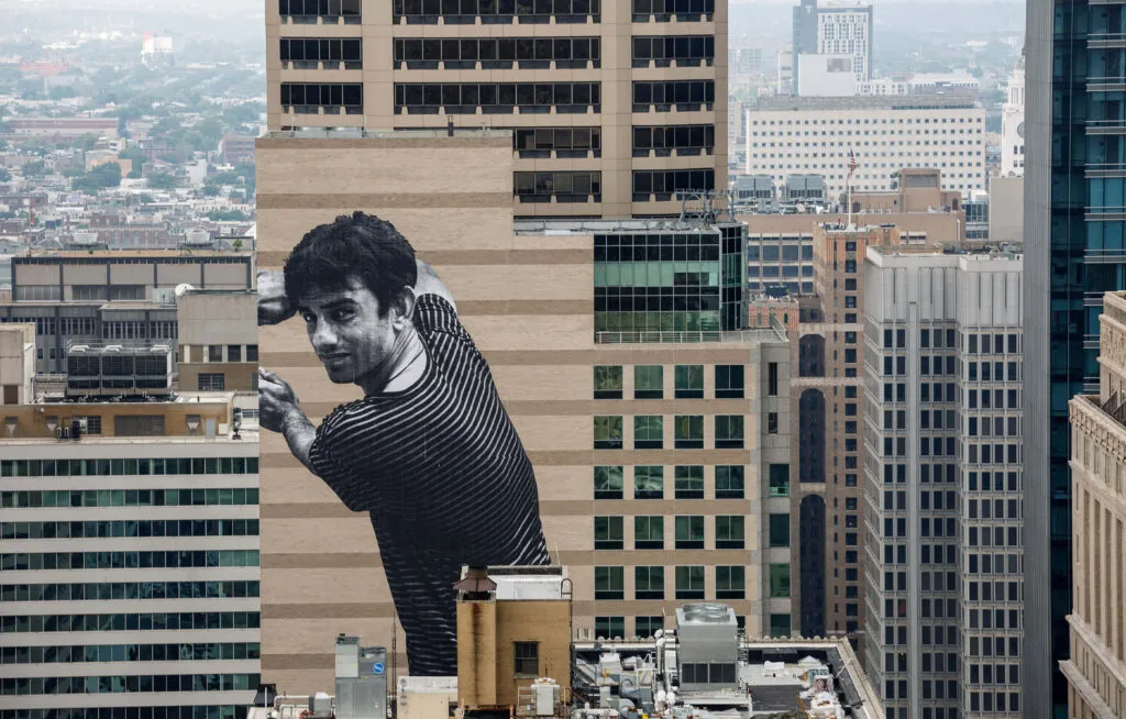 Massive mural of a man on the side of a building on Philadelphia