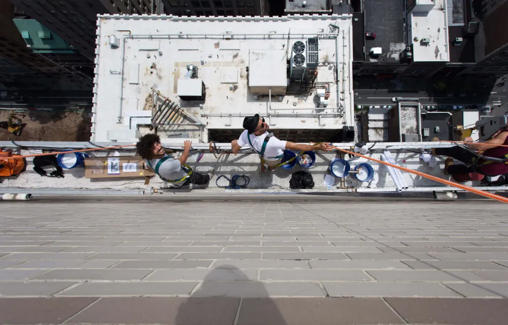 Artists in scaffolding for city-wide art exhibition