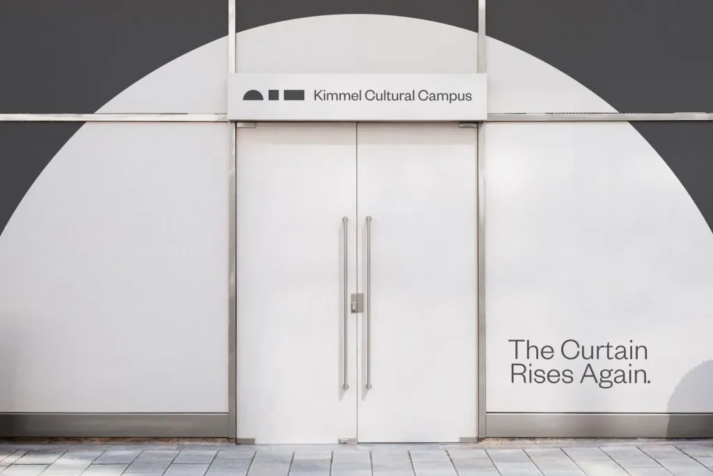 white entrance door with identification signage and painted semicircle, branding by J2 for Kimmel Cultural Campus