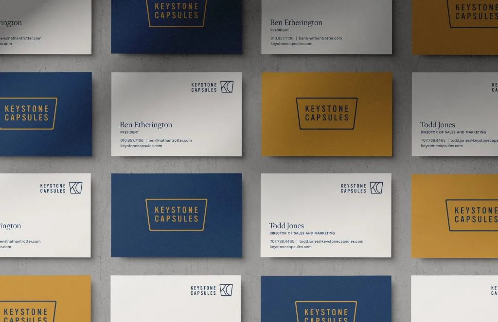 shadows on grid of yellow and blue business cards with clean logos for American wine company