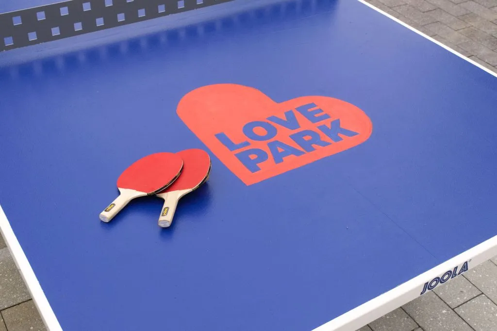 bold heart logo printed on ping pong table