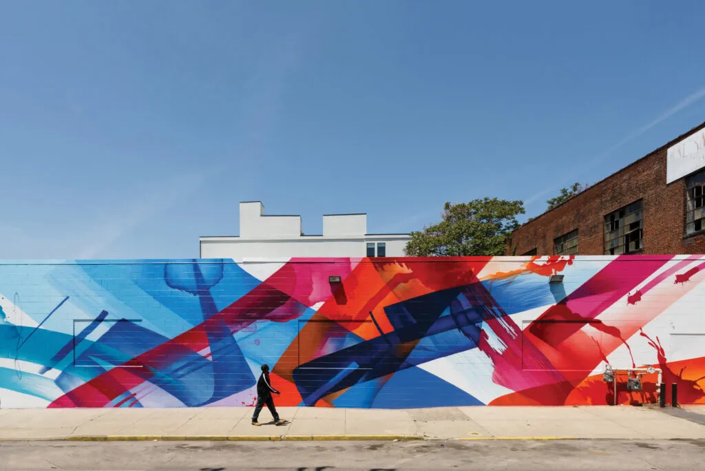 Colorful abstract mural with man walking by