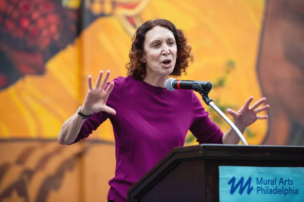 Jane Golden, Executive Director of Mural Arts Philadelphia with podium sign