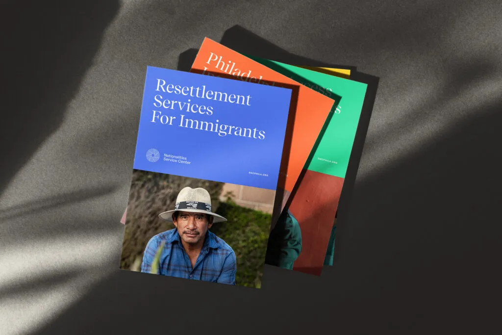 stack of clean blue, orange, and green non-profit brochures