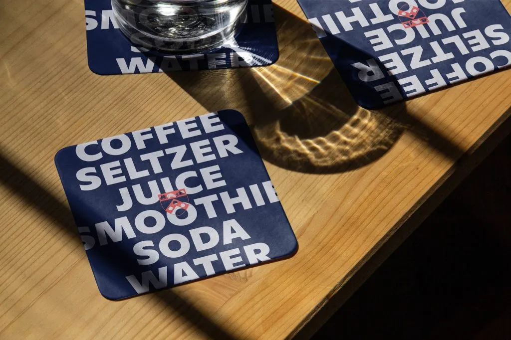 photo of coasters printed with university dining program brand messaging