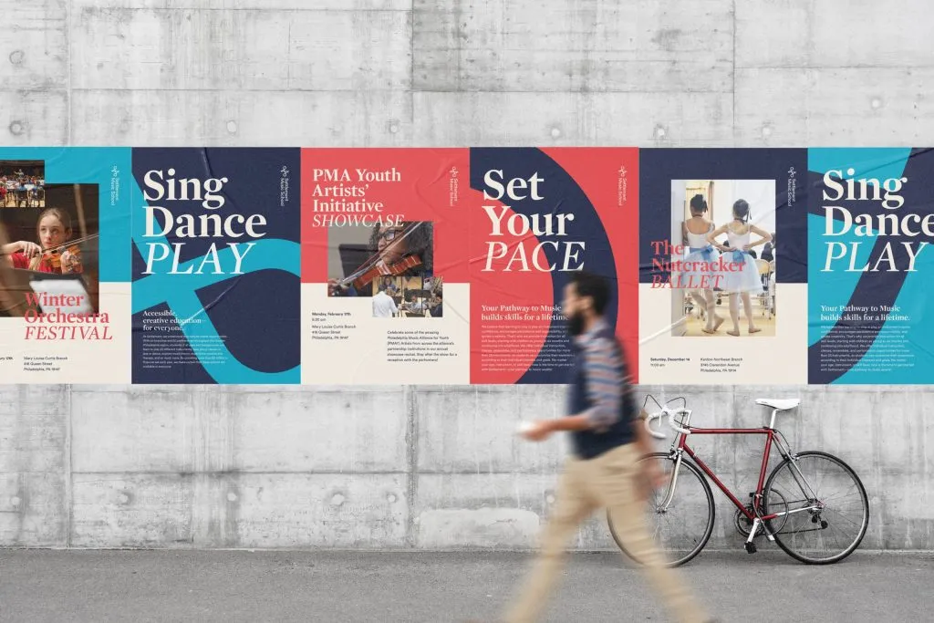 man walking in front of wheat paste posters for private music school