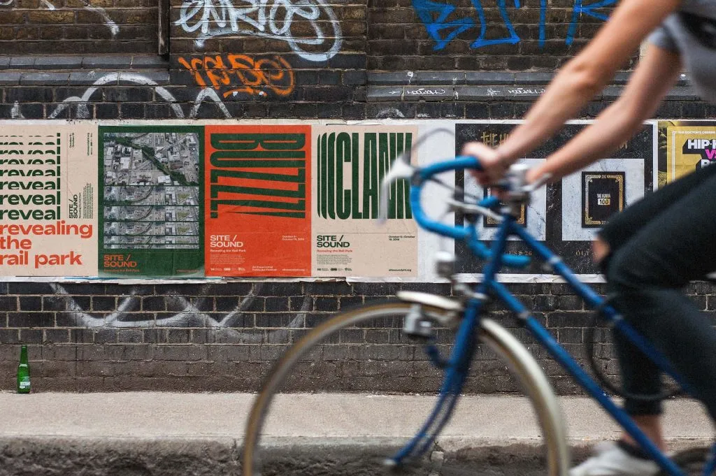 tan and orange wheat-paste posters for arts festival with bold kinetic typography and event information