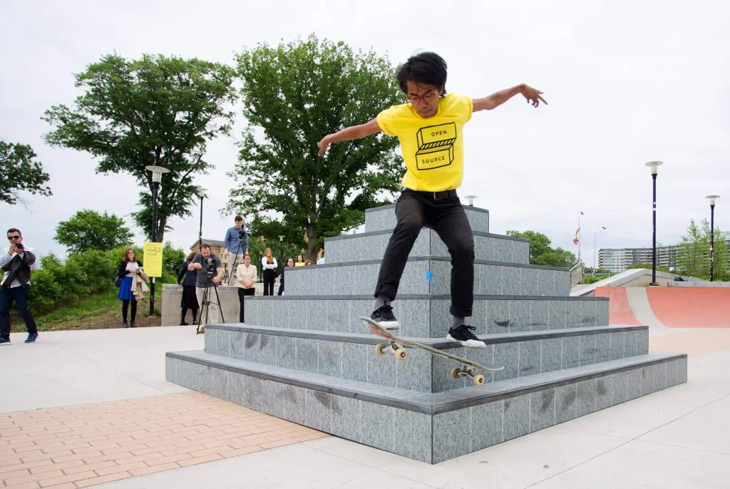 man skating wearing a branded t-shirt for city-wide arts festival for Mural Arts by J2