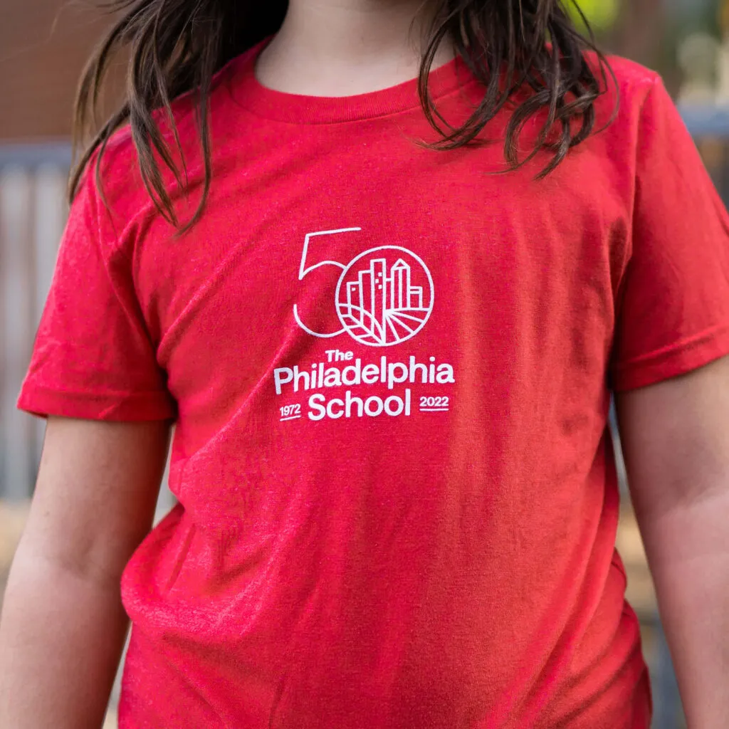 Red t-shirt with The Philadelphia School 50th anniversary logo designed by J2