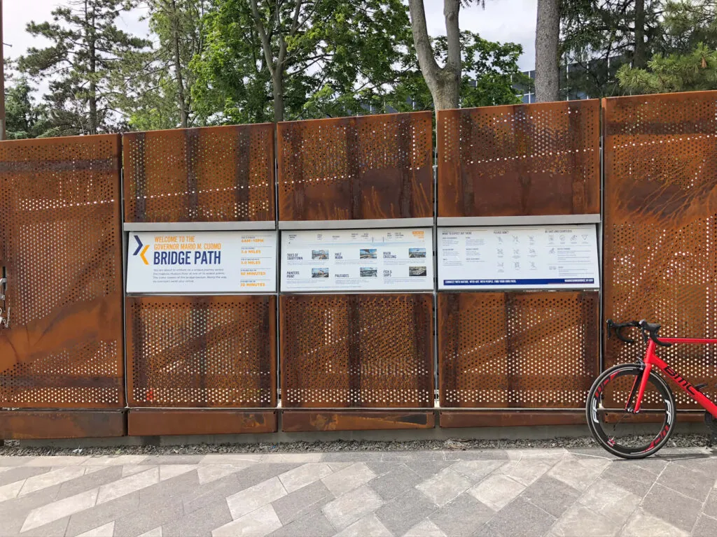 Modern interpretive panel with perforated steel wall background