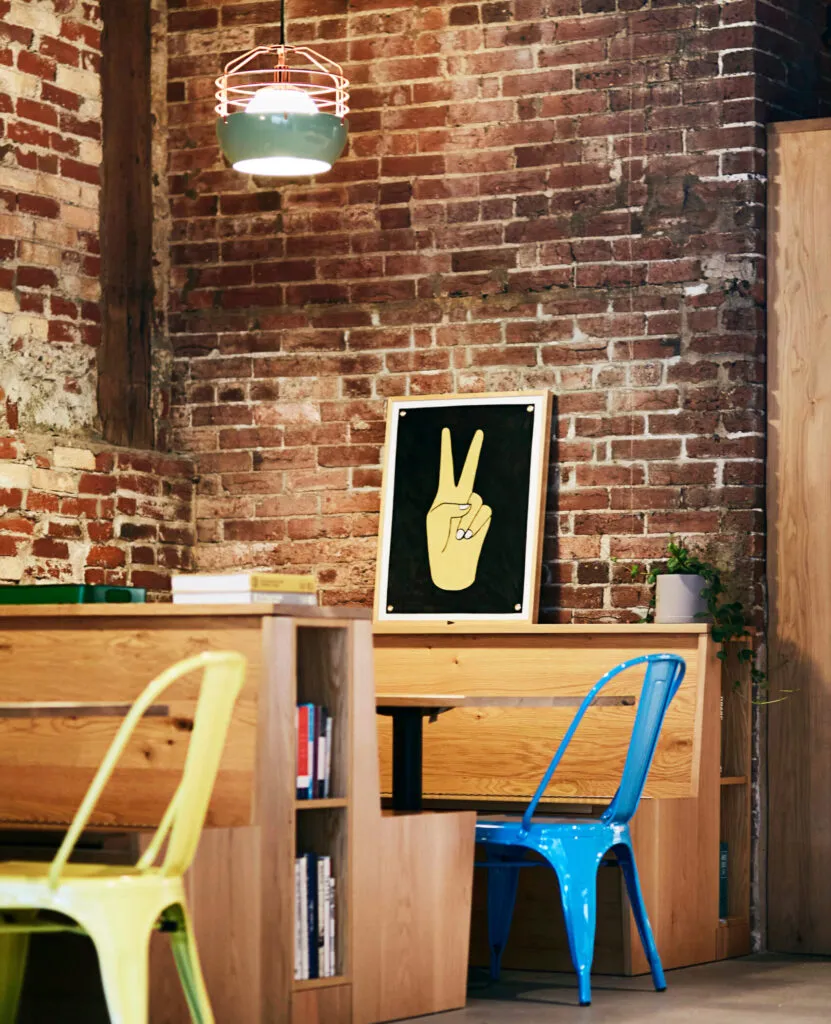 Modern office cafe with colorful industrial chairs and lighting