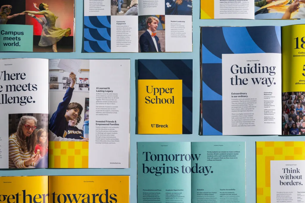 Overhead shot showing collection of branded print marketing materials for private school. Typography and design by J2 for Breck School.