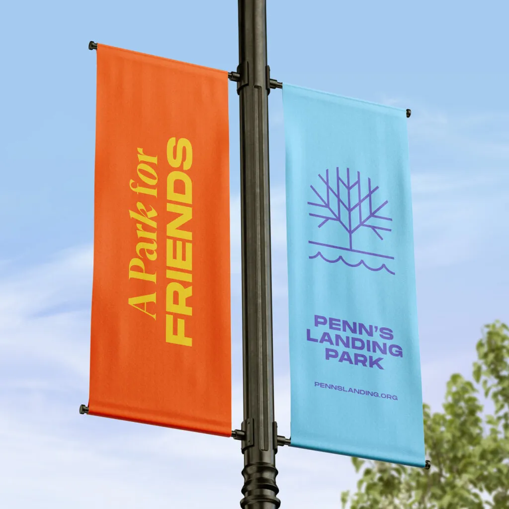 Logo and typography on bright color banners hung from lamppost. Penn's Landing Park branding project by J2.