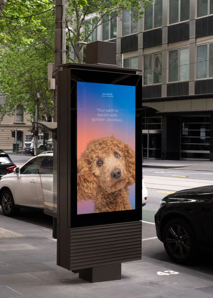 Digital ad showing a dog's face, a gradient color background and modern typeface. Branding and graphic design by J2 for Suveto