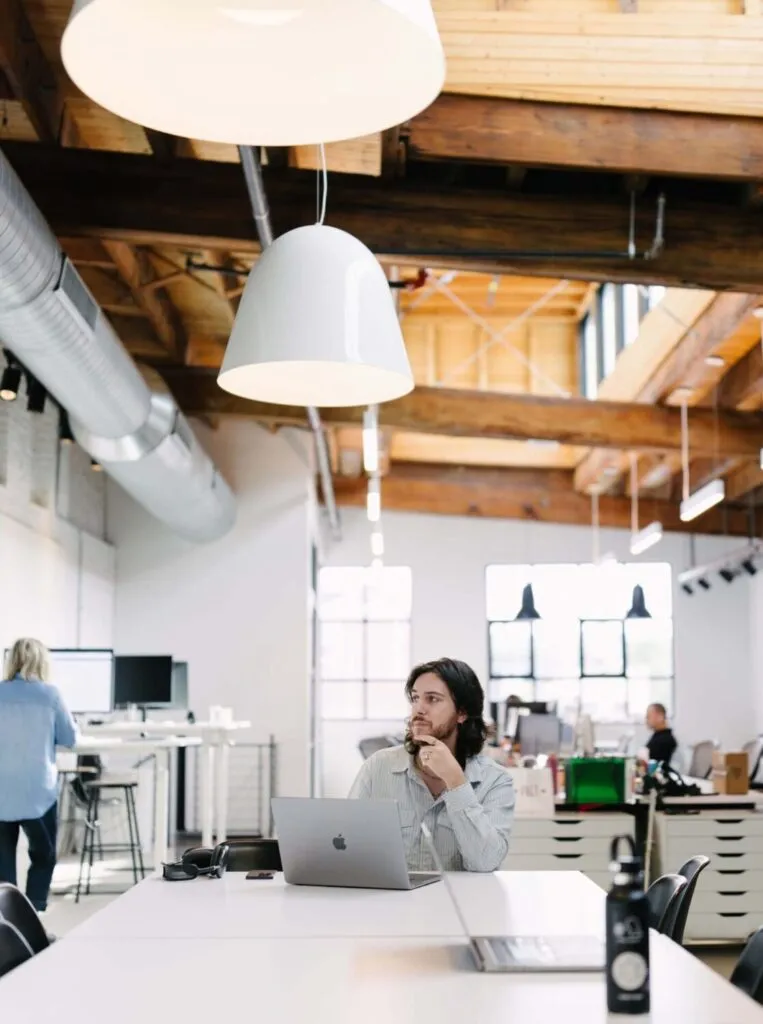 designer working in open industrial modern office space with skylights