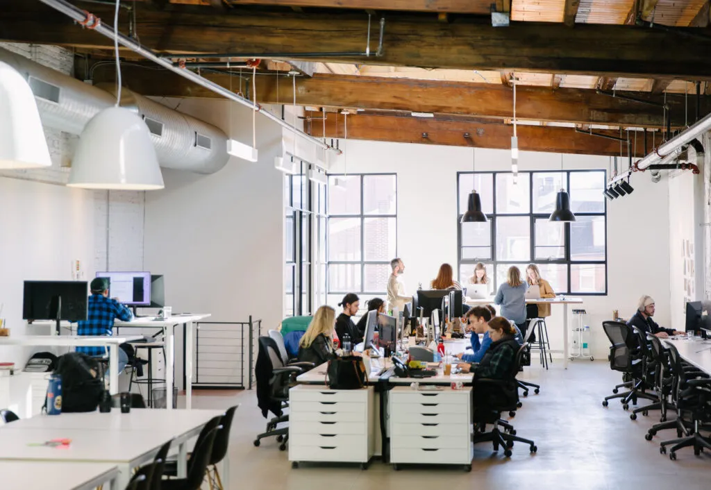 wide angle shot of team at work in modern-industrial design agency office