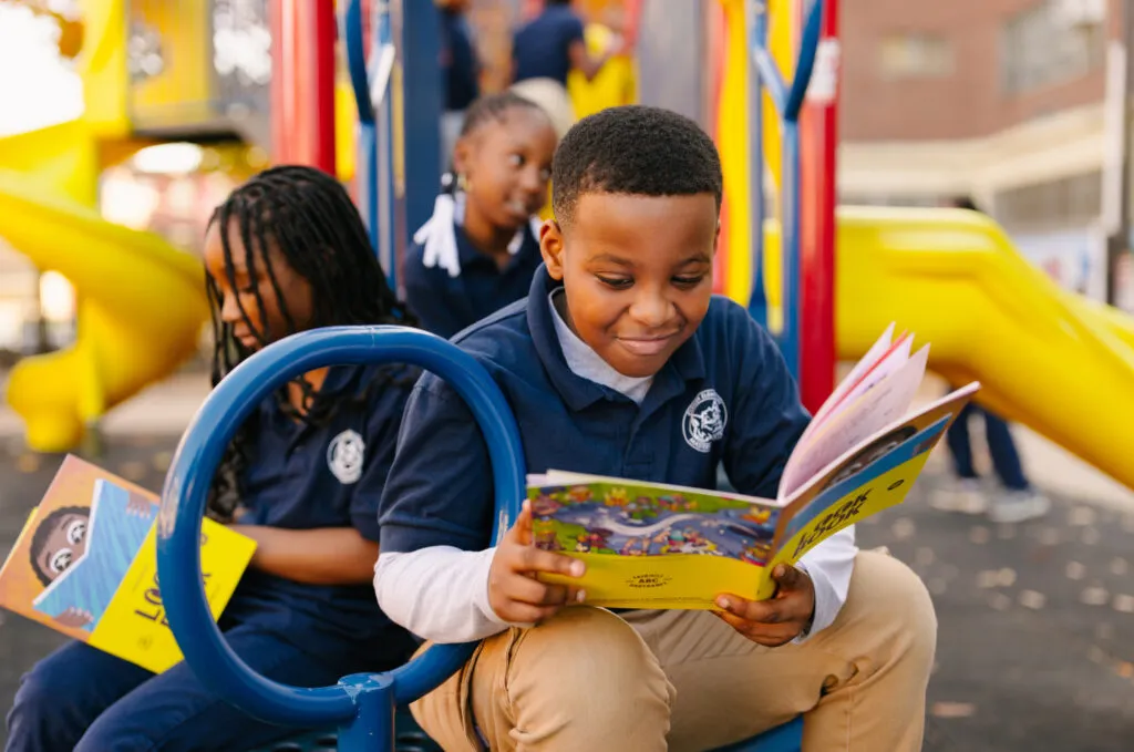 Young boy reading brand look book. Literacy Rich Initiative brand by J2.