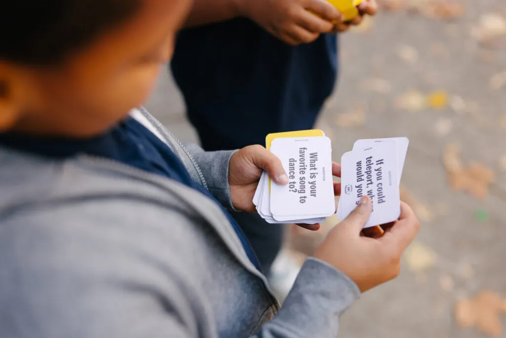 Boy playing with literacy cards. Literacy Rich Initiative brand by J2.