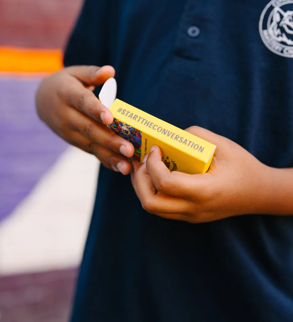 Boy playing with literacy cards. Literacy Rich Initiative brand by J2.