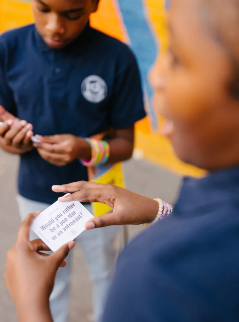 Boy and girl interacting and playing with literacy cards. Literacy Rich Initiative brand by J2.